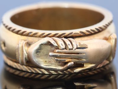A rare and evocative Georgian “Mane in Fede” memorial ring, made in 1774. The name Mane in Fede refers to the traditional motif of two clasped hands, symbolising faith, fidelity and enduring affection. Memorial rings of this type formed an intimate connection between jewellery and remembrance, often incorporating a lock of the deceased’s hair as a tangible keepsake. This example is particularly intriguing for its ingenious concealed compartment.