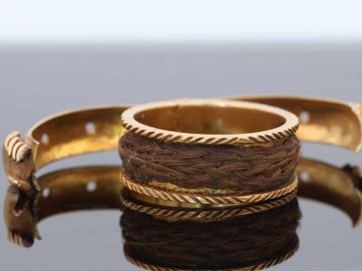 A rare and evocative Georgian “Mane in Fede” memorial ring, made in 1774. The name Mane in Fede refers to the traditional motif of two clasped hands, symbolising faith, fidelity and enduring affection. Memorial rings of this type formed an intimate connection between jewellery and remembrance, often incorporating a lock of the deceased’s hair as a tangible keepsake. This example is particularly intriguing for its ingenious concealed compartment.