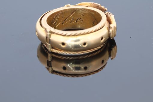 A rare and evocative Georgian “Mane in Fede” memorial ring, made in 1774. The name Mane in Fede refers to the traditional motif of two clasped hands, symbolising faith, fidelity and enduring affection. Memorial rings of this type formed an intimate connection between jewellery and remembrance, often incorporating a lock of the deceased’s hair as a tangible keepsake. This example is particularly intriguing for its ingenious concealed compartment.