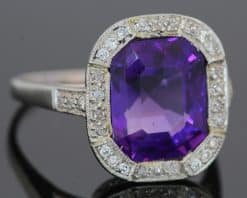 A magnificent 5-carat Siberian amethyst and diamond cluster ring, beautifully presented in platinum. The impressive scale and rich colour of the amethyst make this a particularly striking jewel, with the cool brilliance of the surrounding diamonds creating a refined contrast. Siberian amethyst is prized for its distinctive deep violet colour, and a stone of this substantial size makes a memorable centrepiece for a fine antique or vintage jewellery collection.