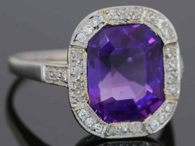 A magnificent 5-carat Siberian amethyst and diamond cluster ring, beautifully presented in platinum. The impressive scale and rich colour of the amethyst make this a particularly striking jewel, with the cool brilliance of the surrounding diamonds creating a refined contrast. Siberian amethyst is prized for its distinctive deep violet colour, and a stone of this substantial size makes a memorable centrepiece for a fine antique or vintage jewellery collection.