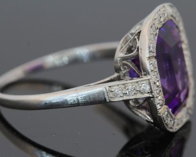 A magnificent 5-carat Siberian amethyst and diamond cluster ring, beautifully presented in platinum. The impressive scale and rich colour of the amethyst make this a particularly striking jewel, with the cool brilliance of the surrounding diamonds creating a refined contrast. Siberian amethyst is prized for its distinctive deep violet colour, and a stone of this substantial size makes a memorable centrepiece for a fine antique or vintage jewellery collection.