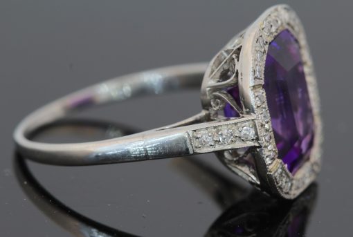 A magnificent 5-carat Siberian amethyst and diamond cluster ring, beautifully presented in platinum. The impressive scale and rich colour of the amethyst make this a particularly striking jewel, with the cool brilliance of the surrounding diamonds creating a refined contrast. Siberian amethyst is prized for its distinctive deep violet colour, and a stone of this substantial size makes a memorable centrepiece for a fine antique or vintage jewellery collection.
