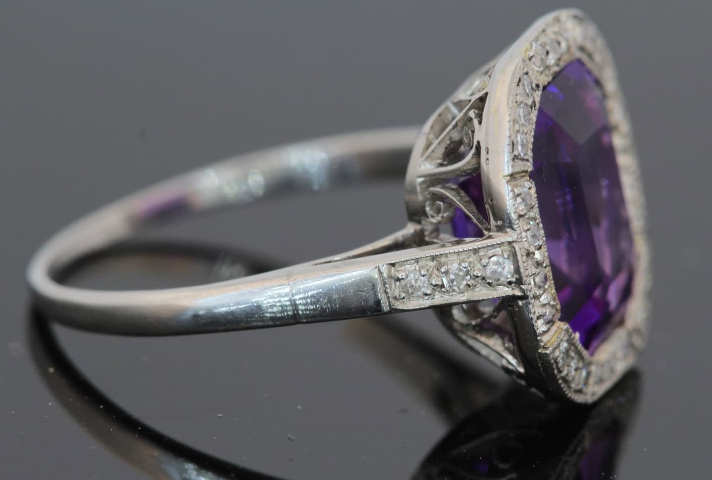 A magnificent 5-carat Siberian amethyst and diamond cluster ring, beautifully presented in platinum. The impressive scale and rich colour of the amethyst make this a particularly striking jewel, with the cool brilliance of the surrounding diamonds creating a refined contrast. Siberian amethyst is prized for its distinctive deep violet colour, and a stone of this substantial size makes a memorable centrepiece for a fine antique or vintage jewellery collection.