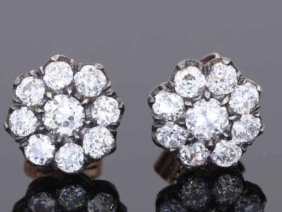 A superb pair of Victorian diamond cluster earrings, showcasing the opulent sparkle and intricate character associated with nineteenth-century jewellery. Together they contain approximately 3 carats of diamonds, creating a wonderfully substantial presence while retaining the elegant proportions of a classic Victorian cluster design.