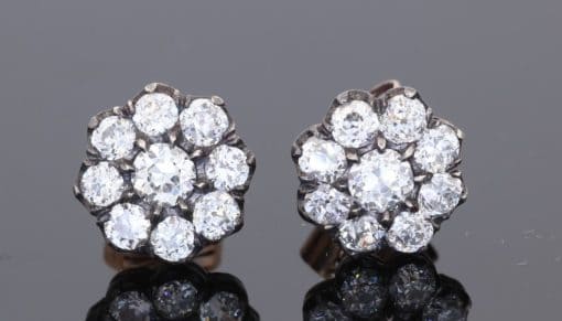 A superb pair of Victorian diamond cluster earrings, showcasing the opulent sparkle and intricate character associated with nineteenth-century jewellery. Together they contain approximately 3 carats of diamonds, creating a wonderfully substantial presence while retaining the elegant proportions of a classic Victorian cluster design.