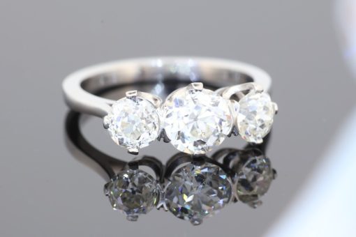 A timeless three-stone diamond ring, beautifully crafted in platinum and designed to celebrate the enduring allure of diamonds. With a substantial centre stone framed by two complementary diamonds, this elegant design offers a harmonious balance of brilliance, proportion and understated sophistication.