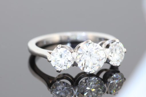 A timeless three-stone diamond ring, beautifully crafted in platinum and designed to celebrate the enduring appeal of diamonds. With a substantial centre stone framed by two complementary diamonds, this elegant design balances presence and proportion, making it a sophisticated choice for an engagement ring or an important addition to a fine jewellery collection.