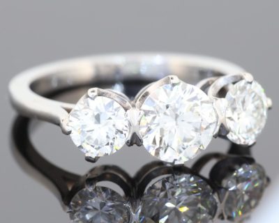 A timeless three-stone diamond ring, beautifully crafted in platinum and designed to celebrate the enduring appeal of diamonds. With a substantial centre stone framed by two complementary diamonds, this elegant design balances presence and proportion, making it a sophisticated choice for an engagement ring or an important addition to a fine jewellery collection.