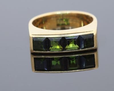 A distinctive Irish gold ring by renowned jewellery designer Rudolph Heltzel, celebrated for his artistic approach to jewellery and his appreciation of fine materials. This elegant creation combines the warmth of gold with the rich colour of tourmalines, reflecting a confident and considered approach to modern jewellery design.
