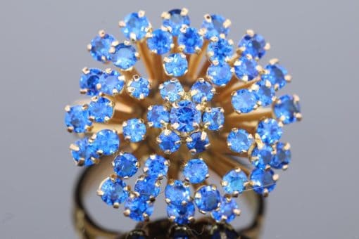 A wonderfully distinctive gem-set dress ring, featuring a dramatic sunburst design that celebrates bold colour and sculptural form. Its generous domed profile and radiating arrangement evoke the glamour of statement jewellery, creating a piece with striking visual impact and individual character.
