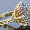 A wonderfully distinctive gem-set dress ring, featuring a dramatic sunburst design that celebrates bold colour and sculptural form. Its generous domed profile and radiating arrangement evoke the glamour of statement jewellery, creating a piece with striking visual impact and individual character.