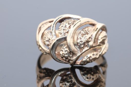 Bold and sculptural, this 9kt gold dress ring showcases the beauty of flowing lines and contemporary design. Its generous domed form gives the piece a distinctive presence, while the wave-like pattern adds movement and visual interest.