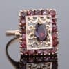 Elegant and richly detailed, this garnet panel ring combines the warm lustre of gold with the deep red tones of garnets. Its decorative filigree work lends the piece a distinctive character, showcasing the enduring appeal of intricate jewellery craftsmanship.