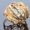 Bold and elegant, this 14kt gold dress ring showcases the enduring appeal of the bombé style. Characterised by its rounded, domed silhouette, the bombé design creates a sculptural presence on the hand, combining substantial proportions with the refined sparkle of diamonds.
