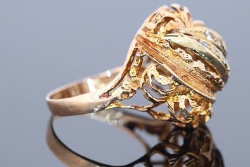 Bold and elegant, this 14kt gold dress ring showcases the enduring appeal of the bombé style. Characterised by its rounded, domed silhouette, the bombé design creates a sculptural presence on the hand, combining substantial proportions with the refined sparkle of diamonds.