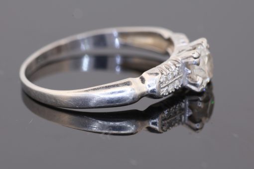 A rare antique diamond ring by Blackensee & Co. of England, dating to circa 1930. Reflecting the elegance of the period, this beautifully detailed jewel combines a central diamond with diamond-set shoulders, creating a sophisticated design with enduring appeal.