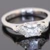 A distinctive three-stone diamond ring that combines geometric elegance with the enduring appeal of platinum. The contrast between a princess-cut centre diamond and trilliant-cut shoulders creates a sophisticated design with crisp lines and a contemporary edge.