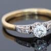 Dating to the antique period, this diamond engagement ring brings together the romantic character of an old-cut diamond and the enduring elegance of 18kt gold. Its classic design, enhanced by pavé-set shoulders, offers a beautiful expression of antique-inspired craftsmanship and timeless appeal.