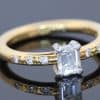 An elegant diamond engagement ring combining the timeless appeal of an emerald-cut diamond with the understated sophistication of 18kt gold. Its clean lines and subtle diamond detailing create a refined design that balances classic elegance with contemporary simplicity.
