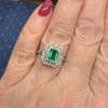 A beautiful Belle Époque emerald and diamond cluster ring, made in France circa 1910 and showcasing the period’s love of delicate platinum construction, fine diamonds and richly coloured gemstones. At its centre is a superb 1-carat Colombian emerald, surrounded by a double halo of diamonds that enhances the stone’s natural colour and gives the ring an elegant, balanced appearance.