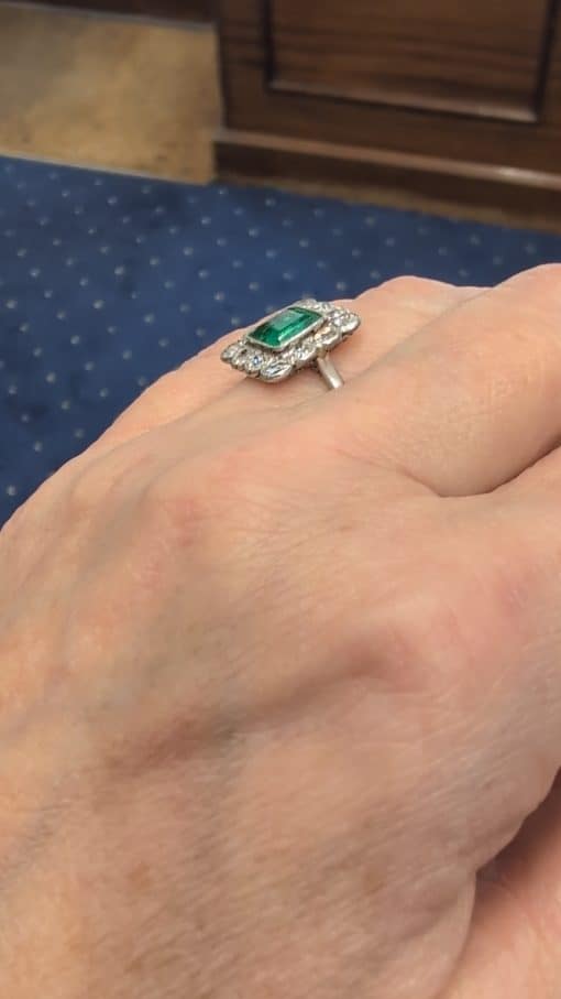 A superb Edwardian emerald and diamond ring, dating to circa 1905 and set in platinum. At its centre is a magnificent 1.5-carat step-cut emerald, distinguished by its exceptional colour and framed by a graceful surround of antique-cut diamonds. The combination of vivid emerald and the cool brilliance of platinum is quintessentially Edwardian, creating a jewel of considerable elegance and character.