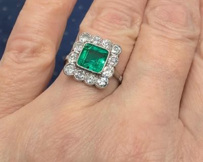 A superb Edwardian emerald and diamond ring, dating to circa 1905 and set in platinum. At its centre is a magnificent 1.5-carat step-cut emerald, distinguished by its exceptional colour and framed by a graceful surround of antique-cut diamonds. The combination of vivid emerald and the cool brilliance of platinum is quintessentially Edwardian, creating a jewel of considerable elegance and character.