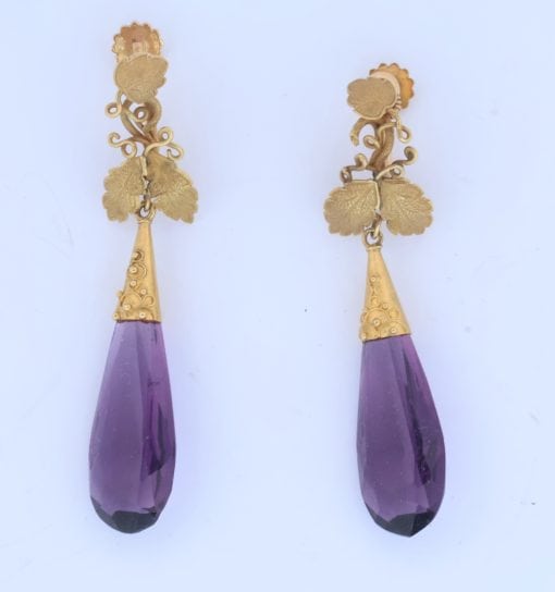 A spectacular antique amethyst parure, made in Italy circa 1880. An impressive suite of matching jewellery, showcasing the rich violet beauty of amethyst and the elaborate craftsmanship characteristic of late 19th-century Italian jewellery. Parures were particularly prized for their coordinated design, with matching pieces intended to be worn together for formal occasions. This exceptional suite is a wonderful example of the Victorian fascination with richly coloured gemstones and grand, coordinated jewels.
