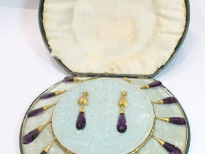 A spectacular antique amethyst parure, made in Italy circa 1880. An impressive suite of matching jewellery, showcasing the rich violet beauty of amethyst and the elaborate craftsmanship characteristic of late 19th-century Italian jewellery. Parures were particularly prized for their coordinated design, with matching pieces intended to be worn together for formal occasions. This exceptional suite is a wonderful example of the Victorian fascination with richly coloured gemstones and grand, coordinated jewels.