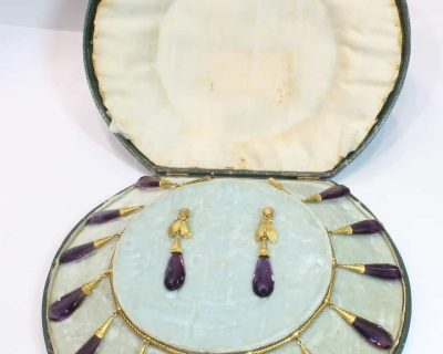 A spectacular antique amethyst parure, made in Italy circa 1880. An impressive suite of matching jewellery, showcasing the rich violet beauty of amethyst and the elaborate craftsmanship characteristic of late 19th-century Italian jewellery. Parures were particularly prized for their coordinated design, with matching pieces intended to be worn together for formal occasions. This exceptional suite is a wonderful example of the Victorian fascination with richly coloured gemstones and grand, coordinated jewels.