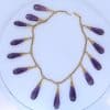 A spectacular antique amethyst parure, made in Italy circa 1880. An impressive suite of matching jewellery, showcasing the rich violet beauty of amethyst and the elaborate craftsmanship characteristic of late 19th-century Italian jewellery. Parures were particularly prized for their coordinated design, with matching pieces intended to be worn together for formal occasions. This exceptional suite is a wonderful example of the Victorian fascination with richly coloured gemstones and grand, coordinated jewels.