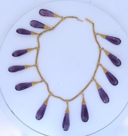 A spectacular antique amethyst parure, made in Italy circa 1880. An impressive suite of matching jewellery, showcasing the rich violet beauty of amethyst and the elaborate craftsmanship characteristic of late 19th-century Italian jewellery. Parures were particularly prized for their coordinated design, with matching pieces intended to be worn together for formal occasions. This exceptional suite is a wonderful example of the Victorian fascination with richly coloured gemstones and grand, coordinated jewels.