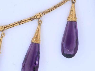 A spectacular antique amethyst parure, made in Italy circa 1880. An impressive suite of matching jewellery, showcasing the rich violet beauty of amethyst and the elaborate craftsmanship characteristic of late 19th-century Italian jewellery. Parures were particularly prized for their coordinated design, with matching pieces intended to be worn together for formal occasions. This exceptional suite is a wonderful example of the Victorian fascination with richly coloured gemstones and grand, coordinated jewels.