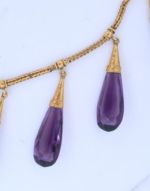 A spectacular antique amethyst parure, made in Italy circa 1880. An impressive suite of matching jewellery, showcasing the rich violet beauty of amethyst and the elaborate craftsmanship characteristic of late 19th-century Italian jewellery. Parures were particularly prized for their coordinated design, with matching pieces intended to be worn together for formal occasions. This exceptional suite is a wonderful example of the Victorian fascination with richly coloured gemstones and grand, coordinated jewels.