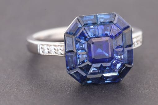 Elegant and contemporary, this sapphire ring showcases the rich colour of sapphires in a refined, modern setting. The invisible setting technique is admired for creating a seamless surface of gemstones, allowing the stones to form a striking, uninterrupted display of colour.