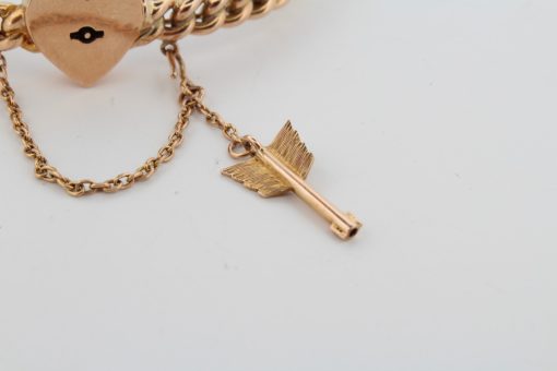 A rare antique 15-karat gold bangle, distinguished by its romantic heart lock and Cupid’s arrow key. Combining symbolic motifs of love and devotion with the enduring appeal of antique gold jewellery, this charming piece offers a glimpse into the sentimental traditions of earlier jewellery design.