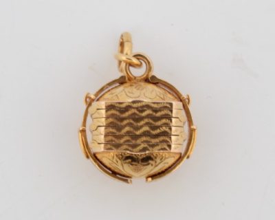 A wonderful antique Portuguese locket, crafted in 19-karat gold. Combining fine gold craftsmanship with an intimate, personal purpose, this distinctive jewel was designed to hold treasured photographs close, preserving memories within an elegant piece of antique jewellery.