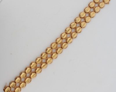 Dating to circa 1960, this elegant two-row gold bracelet reflects the enduring appeal of mid-century jewellery. The 1960s saw a confident approach to gold design, balancing classic elegance with a distinctive sense of style.