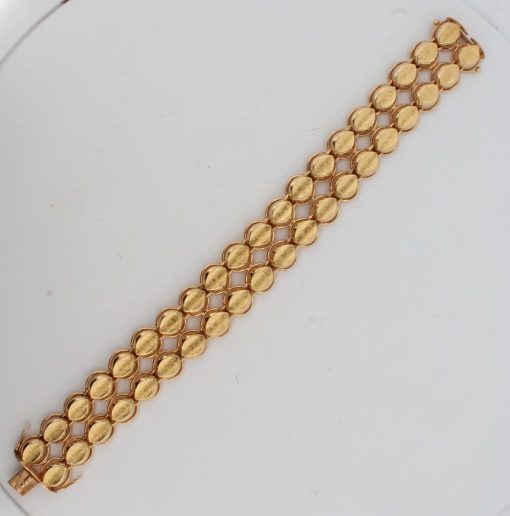 Dating to circa 1960, this elegant two-row gold bracelet reflects the enduring appeal of mid-century jewellery. The 1960s saw a confident approach to gold design, balancing classic elegance with a distinctive sense of style.