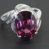 A striking Art Deco ring, combining the bold glamour of the period with an imaginative arrangement of gemstones. Celebrated for its geometric precision and distinctive decorative motifs, Art Deco jewellery often balances strong design with intricate detailing. This ring offers a particularly captivating interpretation, pairing a substantial 9-carat garnet with the refined sparkle of baguette-cut diamonds.