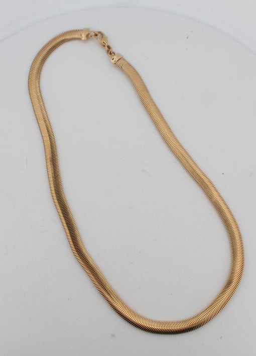 A distinctive gold snake necklace, drawing on one of jewellery’s most enduring and evocative motifs. The serpent has long featured in jewellery design, symbolising renewal, transformation and eternity, making snake jewellery both visually striking and rich in symbolism.