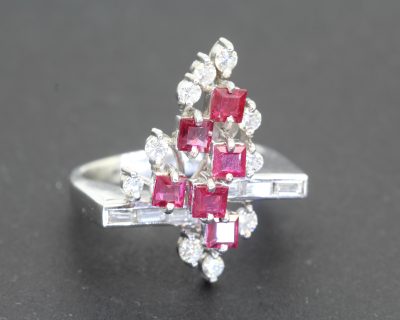 Dating to circa 1960, this vintage ruby and diamond dress ring reflects the elegance and confident style of mid-twentieth-century jewellery. The period embraced expressive designs that combined the rich colour of precious gemstones with the enduring brilliance of diamonds, creating distinctive jewels for both special occasions and everyday sophistication.