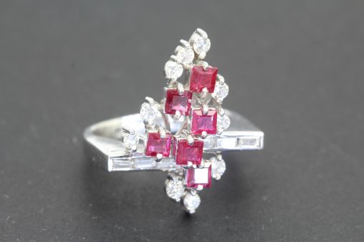 Dating to circa 1960, this vintage ruby and diamond dress ring reflects the elegance and confident style of mid-twentieth-century jewellery. The period embraced expressive designs that combined the rich colour of precious gemstones with the enduring brilliance of diamonds, creating distinctive jewels for both special occasions and everyday sophistication.