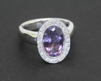 An elegant amethyst and diamond cluster ring, combining the rich violet hues of amethyst with the timeless brilliance of diamonds. This classic gemstone pairing creates a beautiful contrast of colour and sparkle, while the refined setting lends the ring an enduring sophistication.