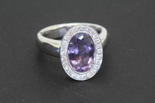 An elegant amethyst and diamond cluster ring, combining the rich violet hues of amethyst with the timeless brilliance of diamonds. This classic gemstone pairing creates a beautiful contrast of colour and sparkle, while the refined setting lends the ring an enduring sophistication.