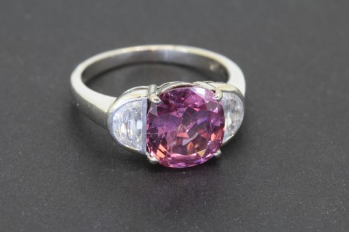 A superb spinel and diamond ring, centred on a magnificent 5-carat spinel from Sri Lanka. Confirmed as unheated, this exceptional gemstone retains its natural character, making it particularly appealing to the discerning coloured gemstone collector. Sri Lanka has a long-standing reputation for producing fine coloured gemstones, and its spinels are prized for their beauty and individuality.