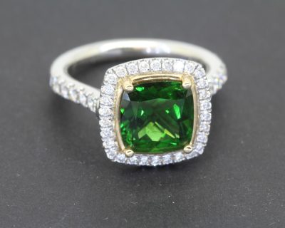 A superb chrome tourmaline and diamond cluster ring, combining the vivid allure of a rare coloured gemstone with the timeless brilliance of diamonds. Set in platinum, this striking jewel brings together rich colour and refined craftsmanship in an elegant cluster design.