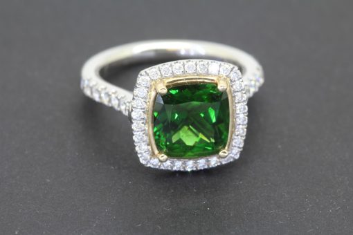 A superb chrome tourmaline and diamond cluster ring, combining the vivid allure of a rare coloured gemstone with the timeless brilliance of diamonds. Set in platinum, this striking jewel brings together rich colour and refined craftsmanship in an elegant cluster design.