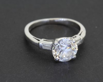 An elegant Art Deco diamond ring, combining the glamour of the 1920s and 1930s with the enduring appeal of an exceptional diamond. The Art Deco period is celebrated for its bold geometry, refined symmetry and sophisticated design, making jewellery from this era particularly desirable to collectors who appreciate distinctive craftsmanship and timeless style.