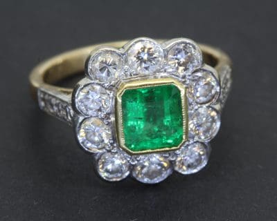 A captivating emerald and diamond cluster ring, centred on a beautiful 1.2-carat Colombian emerald. Renowned for their rich colour and enduring desirability, Colombian emeralds have long been prized by jewellery connoisseurs and collectors. The combination of emerald and diamonds creates a classic pairing of vibrant colour and brilliant sparkle.